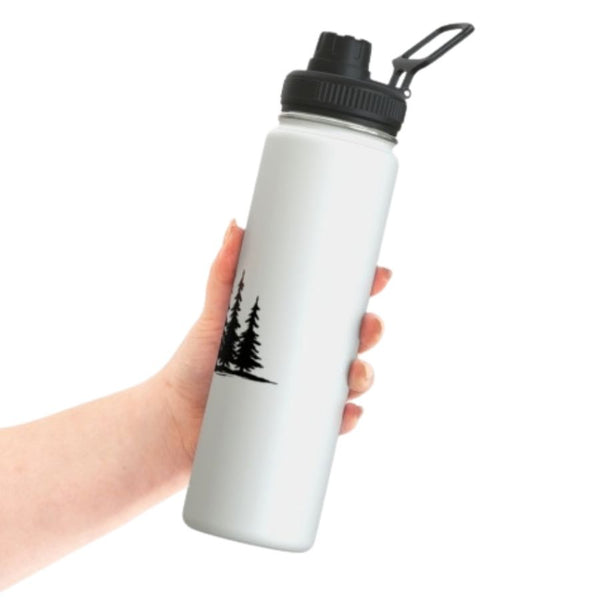 Spruce Trees Stainless Steel water bottle from the side, held in a person's hand.