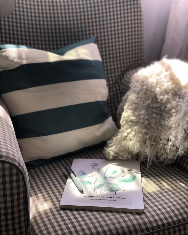 Slate Gray cushion cover on a cozy chair - from Spruce and Heron.